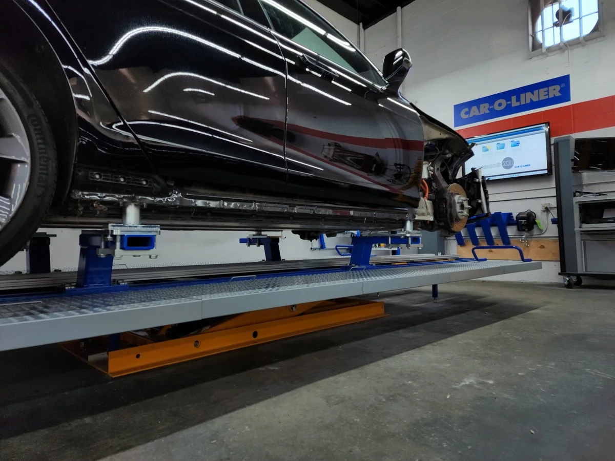A vehicle mounted on repair equipment inside E3