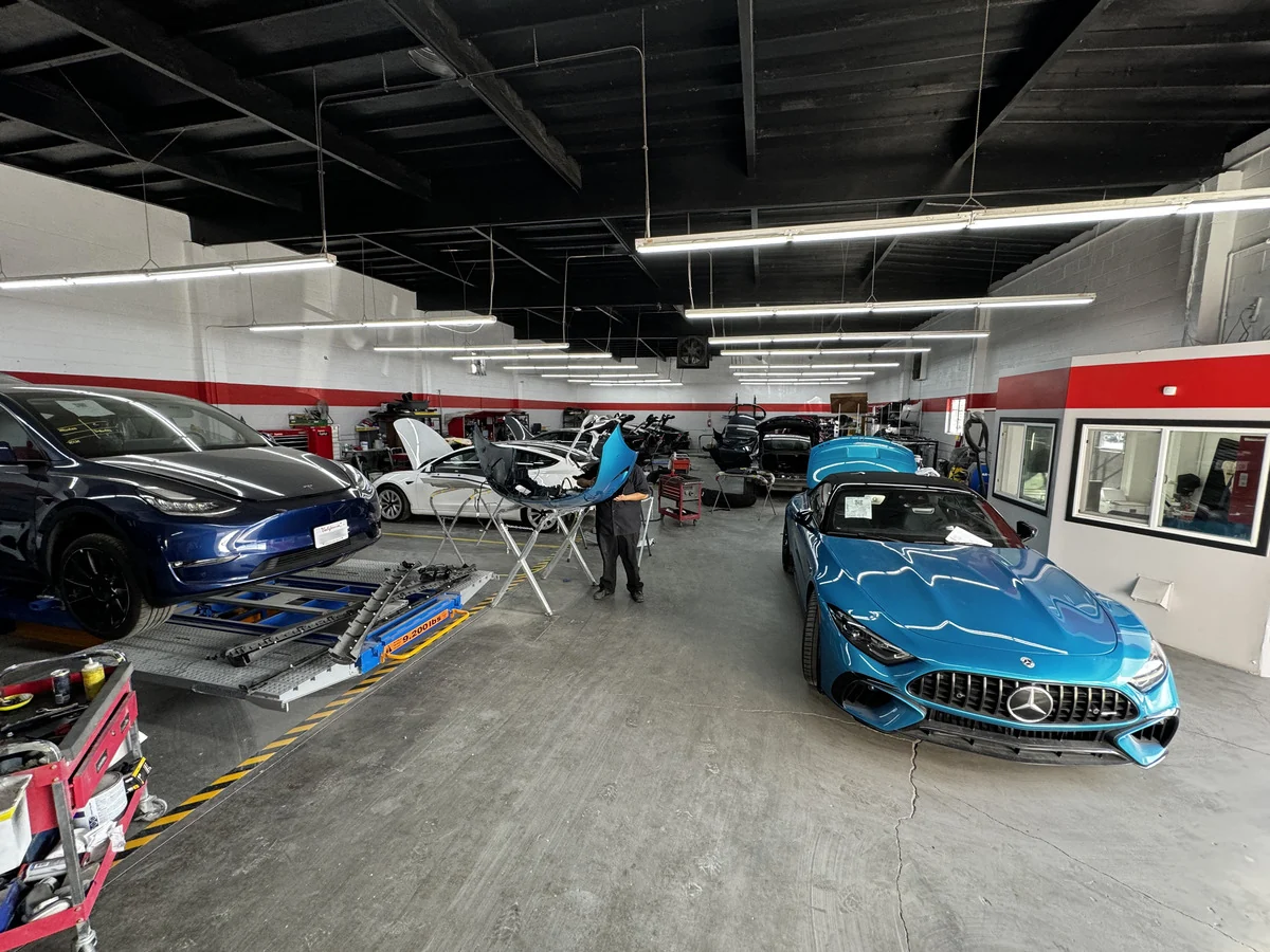 Vehicles and repair equipment on E3’s working shop floor